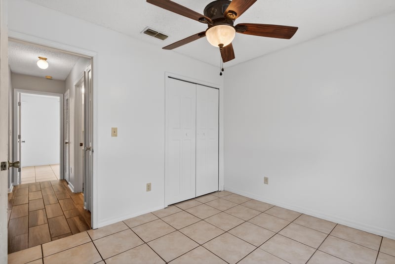 Hallway with tile floor and closets at 2164 Orangewood St, Middleburg, FL 32068