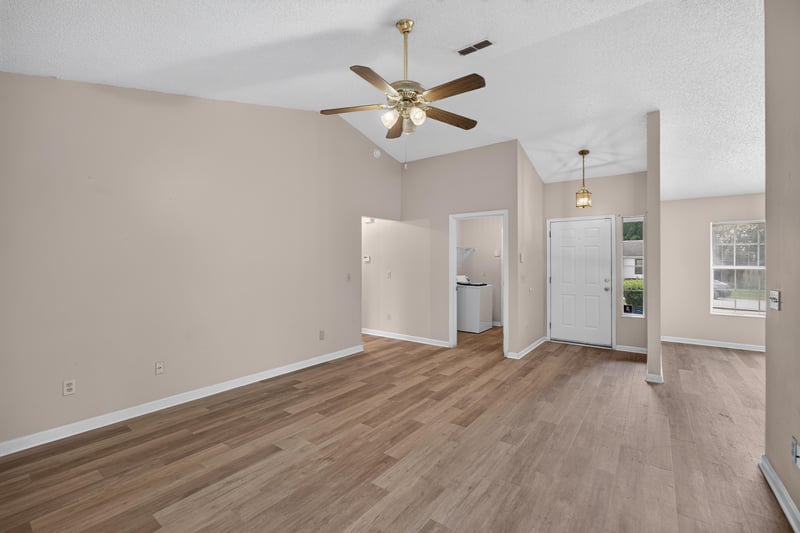 Living room with vaulted ceiling and ceiling fan at 6646 Shiloh Creek Dr