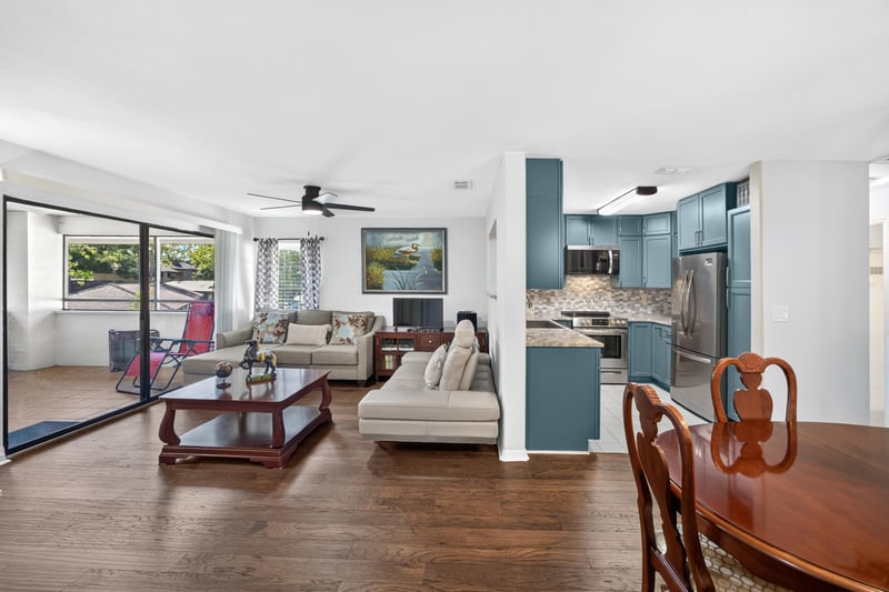 Living room with sliding glass doors and kitchen pass-through at 10150 Belle Rive Blvd, Jacksonville, FL