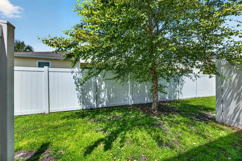 Fenced backyard with lawn and tree at 2837 Black Buck Cir, Jacksonville, FL 32225