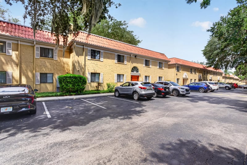Two-story stucco condo building and parked cars at 5811 Atlantic Blvd unit 47, Jacksonville, FL 32207