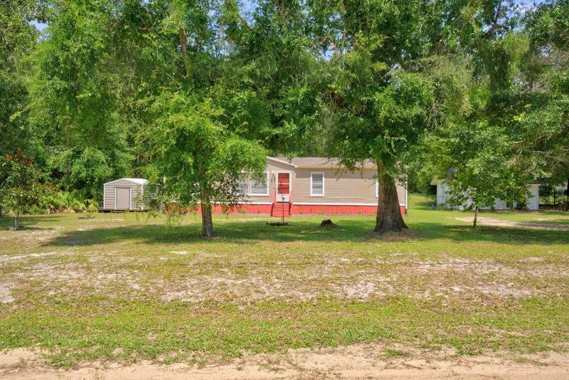 Distant yard view with storage shed and home at 2549 Snapdragon Ave, Middleburg, FL 32068