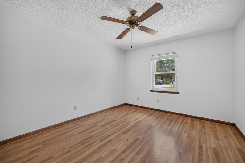 Empty bedroom with wood floor and single window at 2460 San Sago Ln, Jacksonville, FL