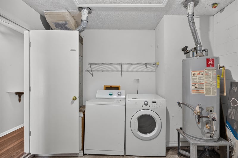 Laundry closet with washer, dryer and water heater at 7329 Lawn Tennis Ln, Jacksonville, FL