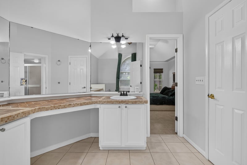 Primary bathroom vanity with granite counter at 12810 Swamp Owl Ln