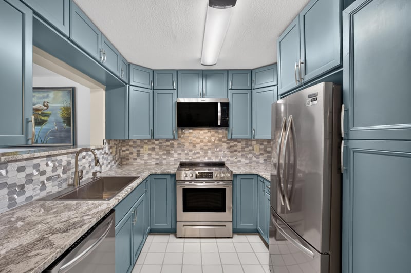 Kitchen with range, refrigerator, and tile backsplash at 10150 Belle Rive Blvd, Jacksonville, FL