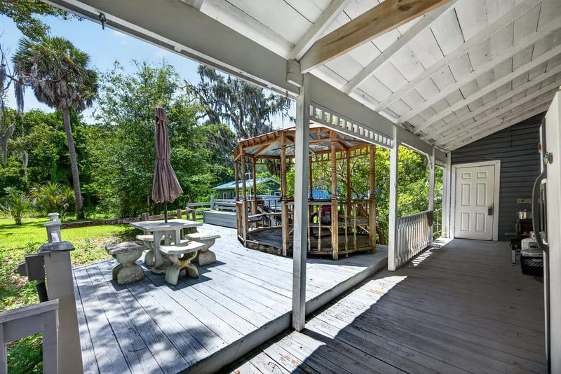 Covered porch with gazebo and patio seating at 1173 US-17, Satsuma, FL 32189