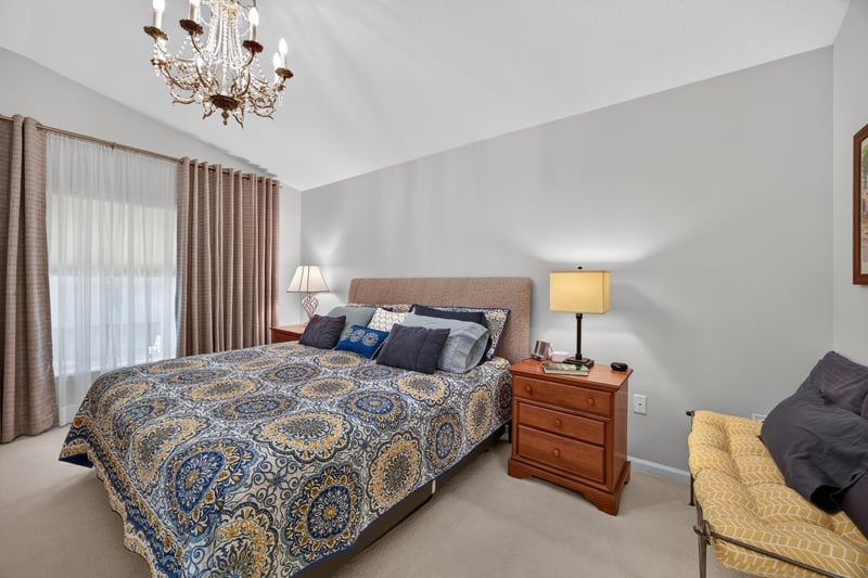 Primary bedroom with blue-patterned bedspread at 11225 Water Spring Cir, Jacksonville, FL 32256