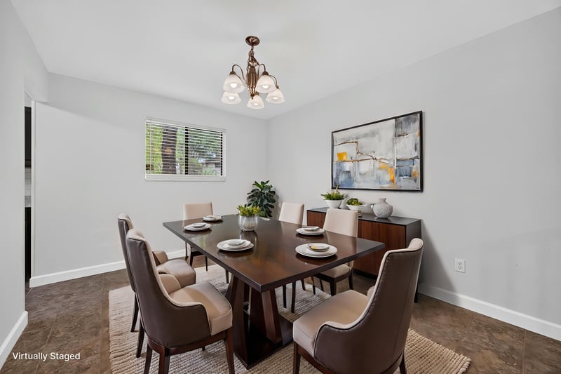 Dining area with table setting, virtually staged, at 3801 Crown Point Rd unit 2061, Jacksonville, FL 32257