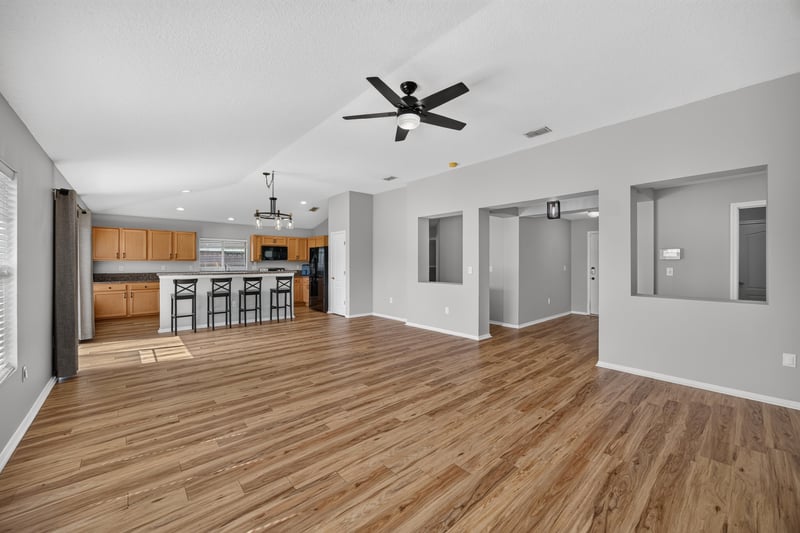 Open living and dining area with wood floors at 7545 Lirope St, Jacksonville, FL 32244