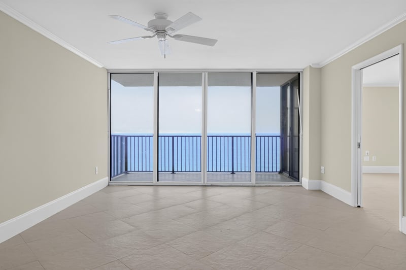 Living room with floor-to-ceiling windows and ocean view at 1301 1st St S