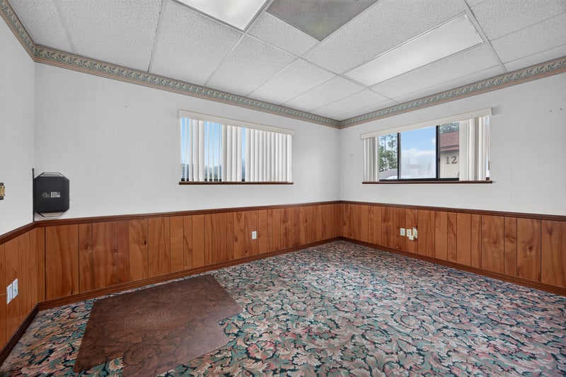 Room with floral carpet and wood wainscoting at 1543 Kingsley Ave #19, Orange Park, FL 32073