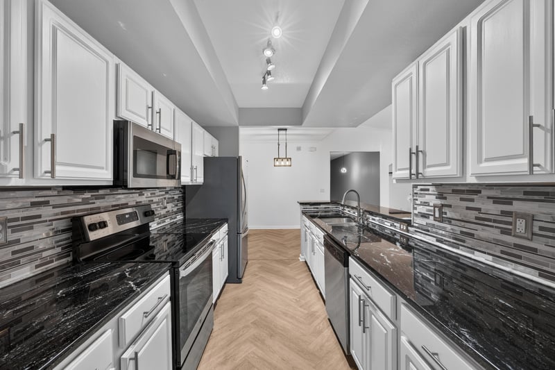 Kitchen with dark counters and stainless appliances at 10075 Gate Pkwy unit 1905, Jacksonville, FL 32246