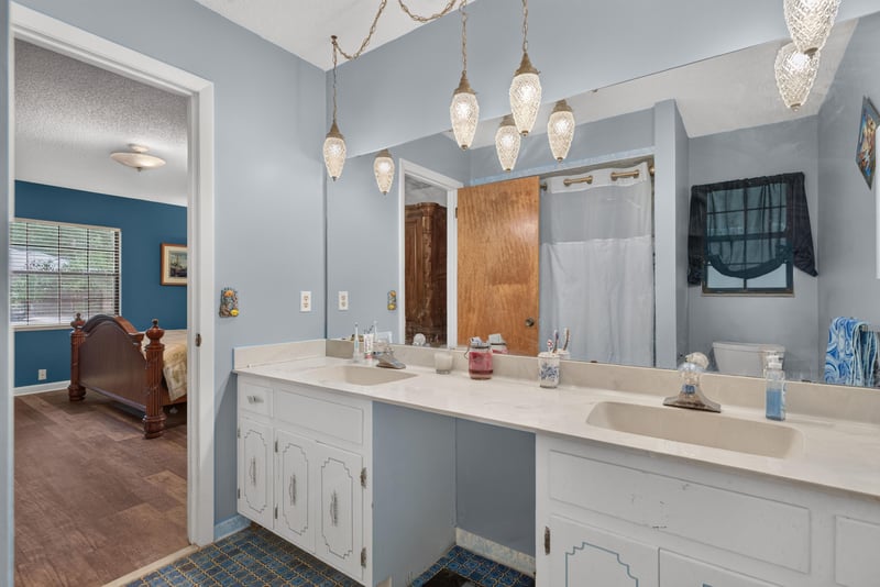 Primary bathroom vanity with mirror and shower at 3249 Maryland Ave, Green Cove Springs, FL