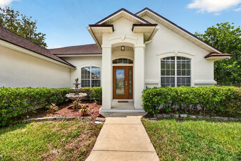 Front entry with columns and landscaped walkway at 2480 Ridge Will Dr, Jacksonville, FL 32246