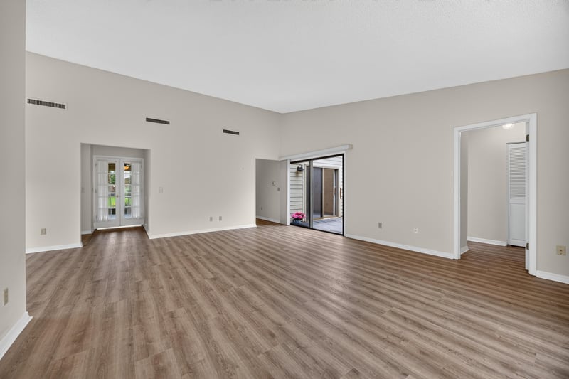 Empty hallway and living area with wood floors at 3407 Fairbanks Grant Rd N, Jacksonville, FL 32223