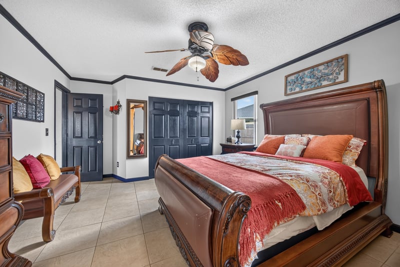 Bedroom with sleigh bed and bench at 6931 Cane Grass Ln E, Jacksonville, FL 32244