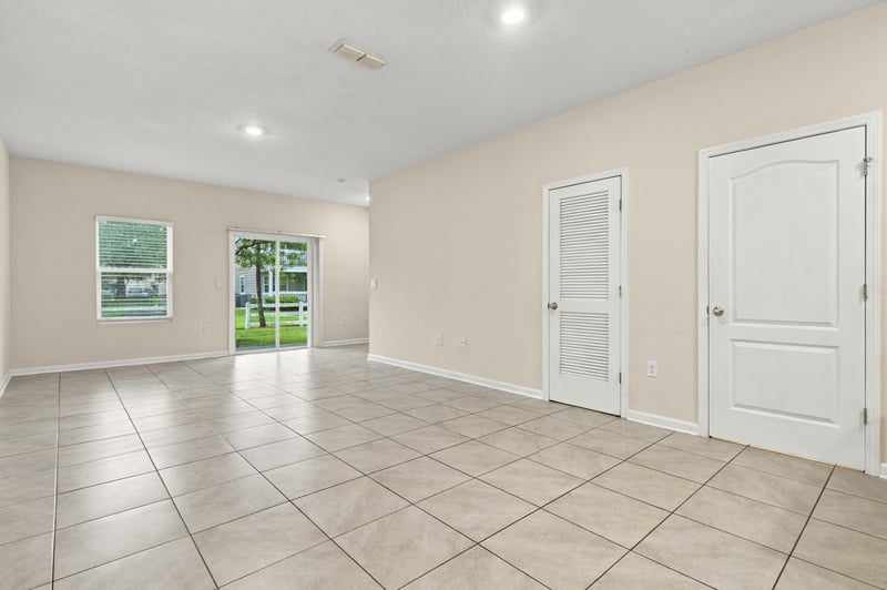 Empty living room with tile floors and natural light at 9555 Star Dr, Jacksonville, FL 32256
