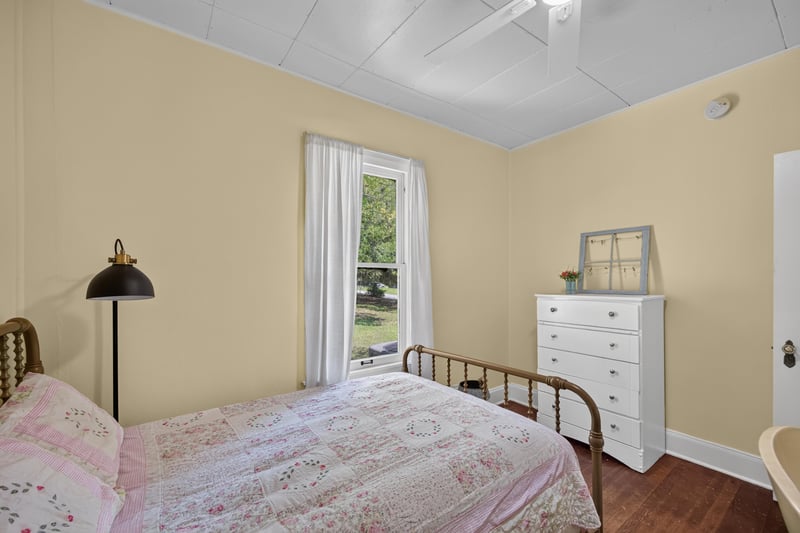 Bedroom with bed and dresser at 101 N Lake St, Crescent City, FL
