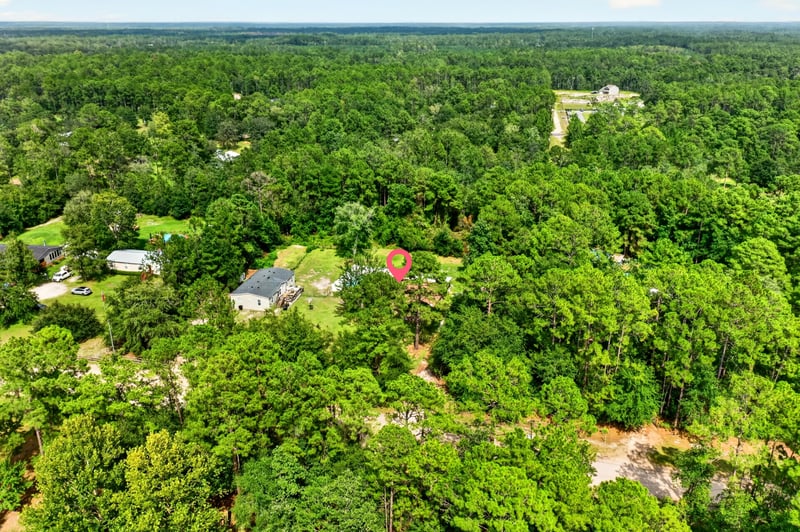 Aerial view of the property within wooded surroundings in Middleburg, FL
