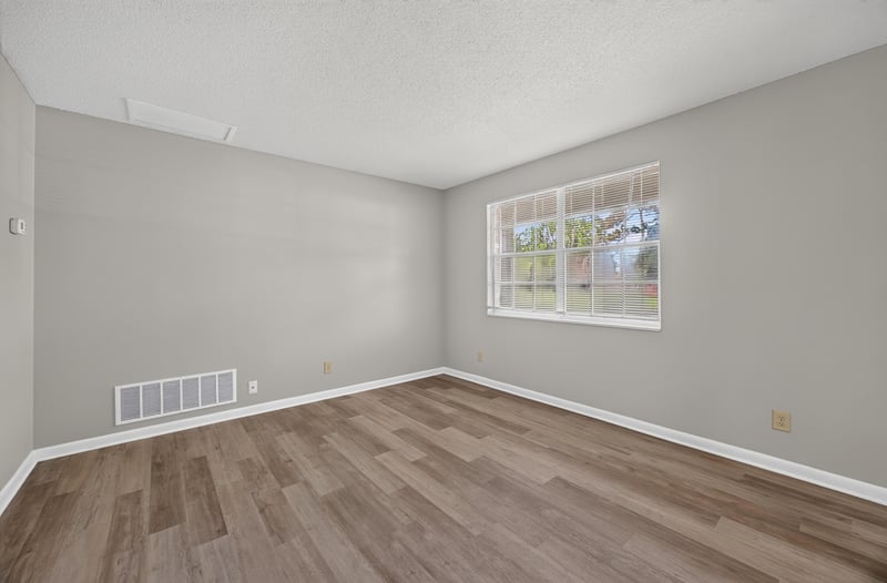 Living room with window and wood-look flooring at 12351 Condor Dr