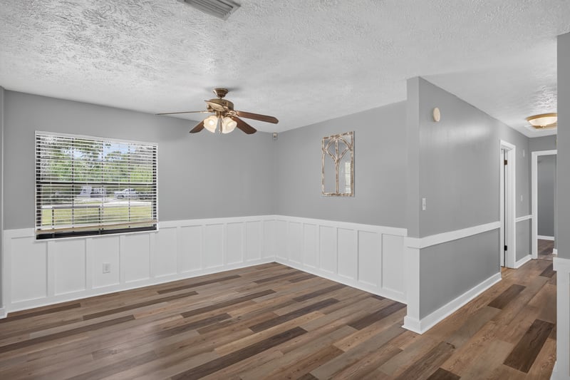 Living space with wainscoting and wood-look floors at 6757 Deer Springs Rd, Keystone Heights, FL 32656