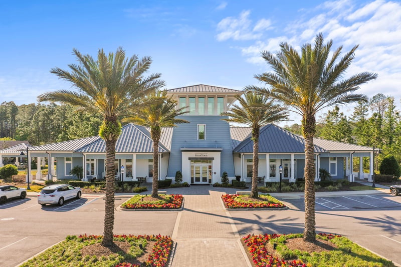 Clubhouse front exterior with palm trees in St. Johns, FL