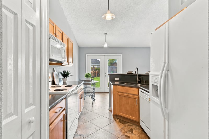 Kitchen with white appliances and tile floor at 11197 Illford Dr
