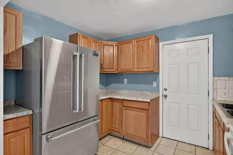 Kitchen with stainless refrigerator and granite counters at 2841 Ernest St, Jacksonville, FL 32205