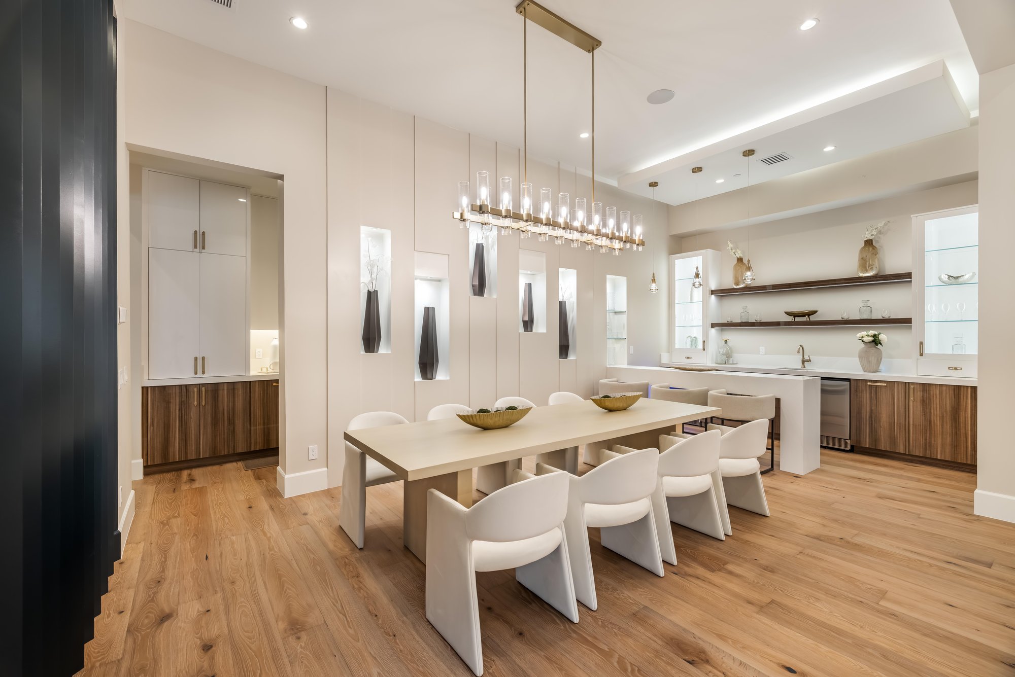 Dining room with a long table under a linear chandelier