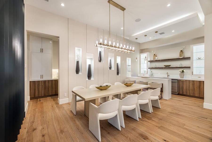Dining room with a long table under a linear chandelier