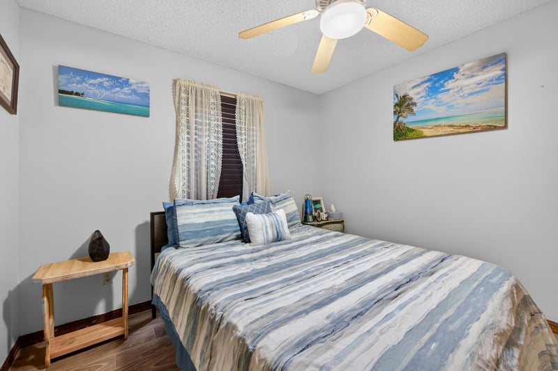 Bedroom with coastal artwork and wood flooring at 981 Marble Ridge Dr, Orange Park, FL 32065