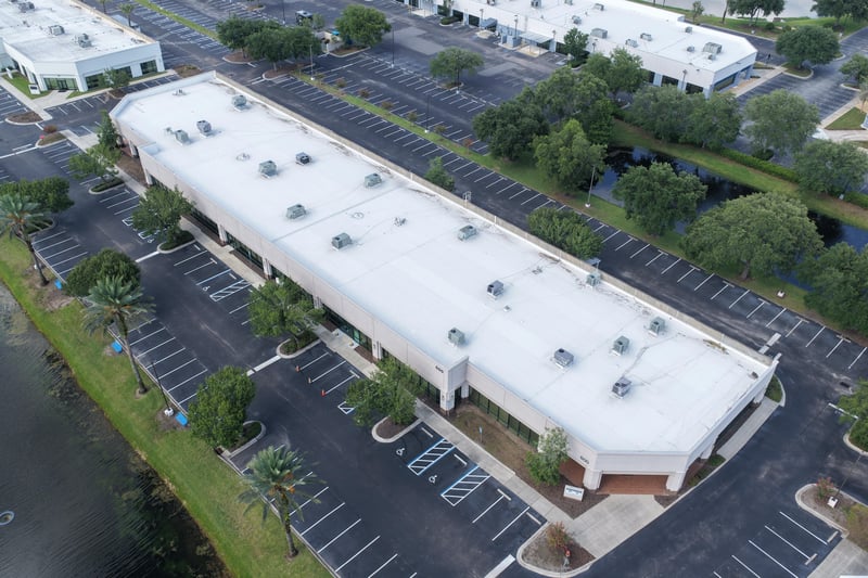 Aerial view of a building roof and surrounding parking lot at 10550 Deerwood Park Blvd, Jacksonville, FL 32256