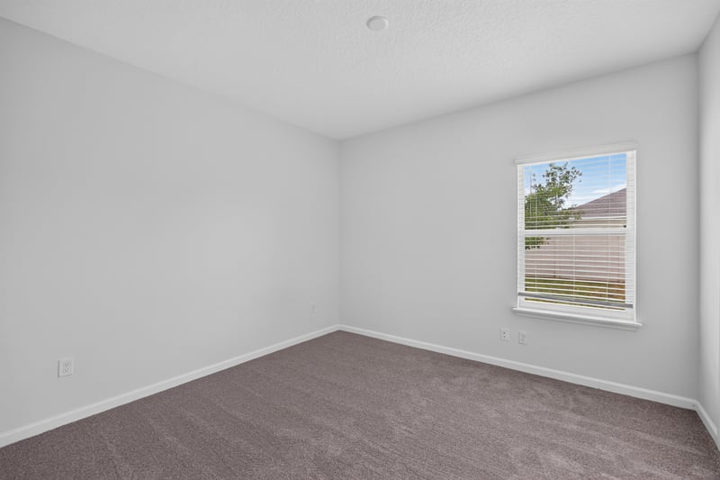 Bedroom corner with window at 9905 Ansley Lake Dr, Jacksonville, FL