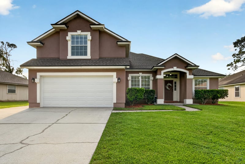Front exterior with arched gable and two-car garage at 3112 Silverado Cir, Green Cove Springs, FL 32043