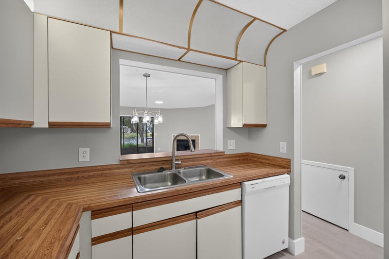 Kitchen counter and pass-through mirror at 3801 Crown Point Rd, Jacksonville, FL 32257