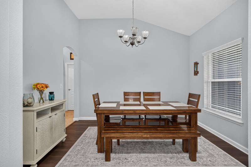 Dining area with wood table and area rug at 538 Porta Rosa Circle, St. Augustine, FL 32092