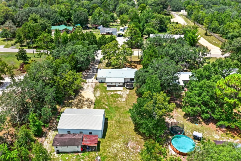 Aerial view of a pool and wooded land in Keystone Heights, FL