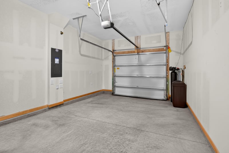 Garage interior with door and electrical panel at 4024 Bay Hawk Ct, Jacksonville, FL