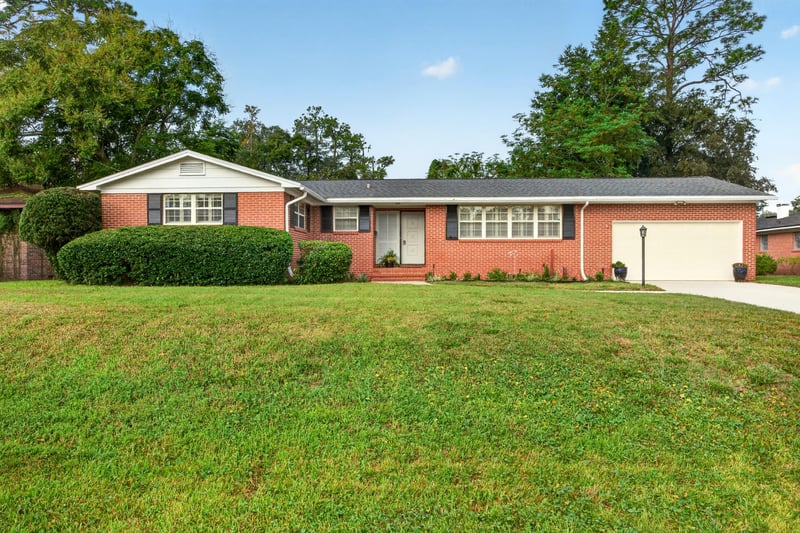 Front exterior of brick ranch home with two-car garage at 1834 Memory Ln, Jacksonville, FL