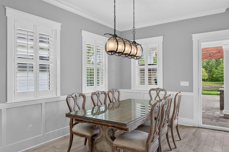 Dining room with chandelier and plantation shutters at 186 Freshwater Dr