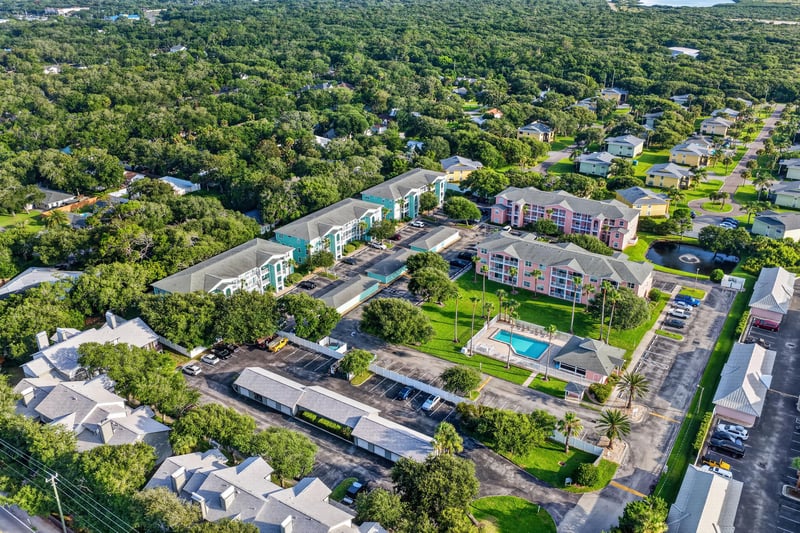 Aerial view of neighboring rooftops and a community pool in St. Augustine, FL