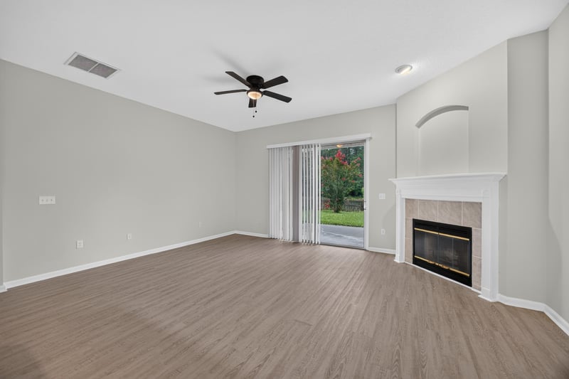 Living room with fireplace and ceiling fan at 706 Bonaparte Dr, Jacksonville, FL 32218