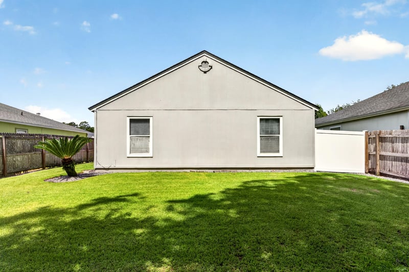 Side exterior wall with fenced backyard at 3067 Wavering Ln, Middleburg, FL 32068