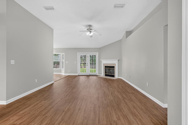 Entry hall with wood floor leading to open rooms at 12949 Chets Creek Dr S, Jacksonville, FL 32224