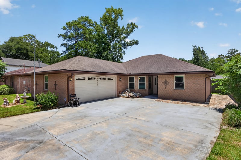 Front exterior with driveway and brick ranch facade at 2460 San Sago Ln, Jacksonville, FL