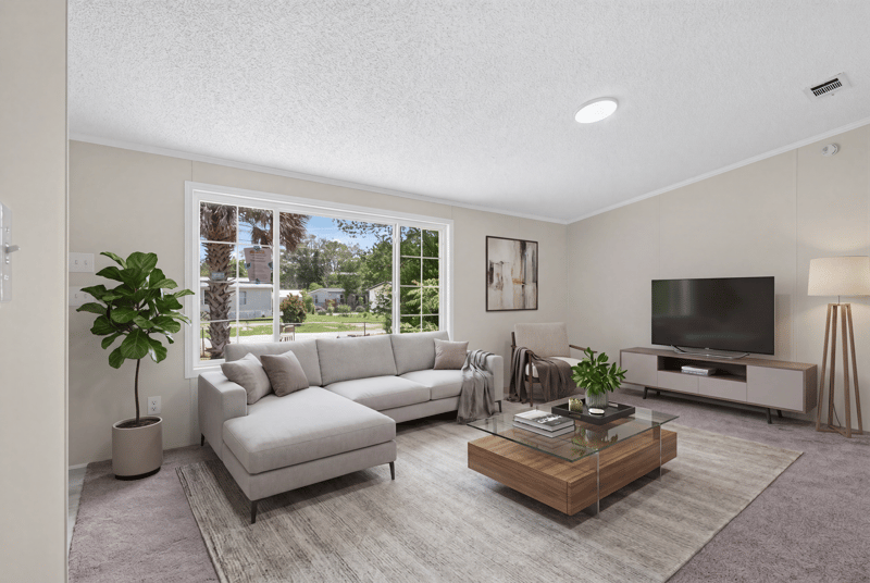 Living room staged with sofa and TV at 7603 Coach Park Dr, Jacksonville, FL 32244