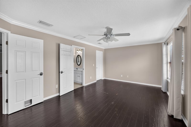 Bedroom with carpet and two doors at 1493 Greyfield Dr, St. Augustine, FL 32092