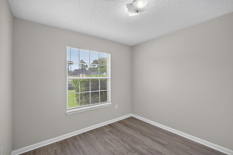 Bedroom with window and wood flooring at 8519 Blazing Star Ct, Jacksonville, FL 32210