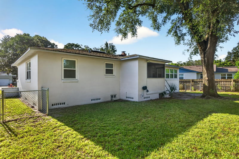 Rear exterior view of the home and yard at 6338 Mercer Cir W, Jacksonville, FL